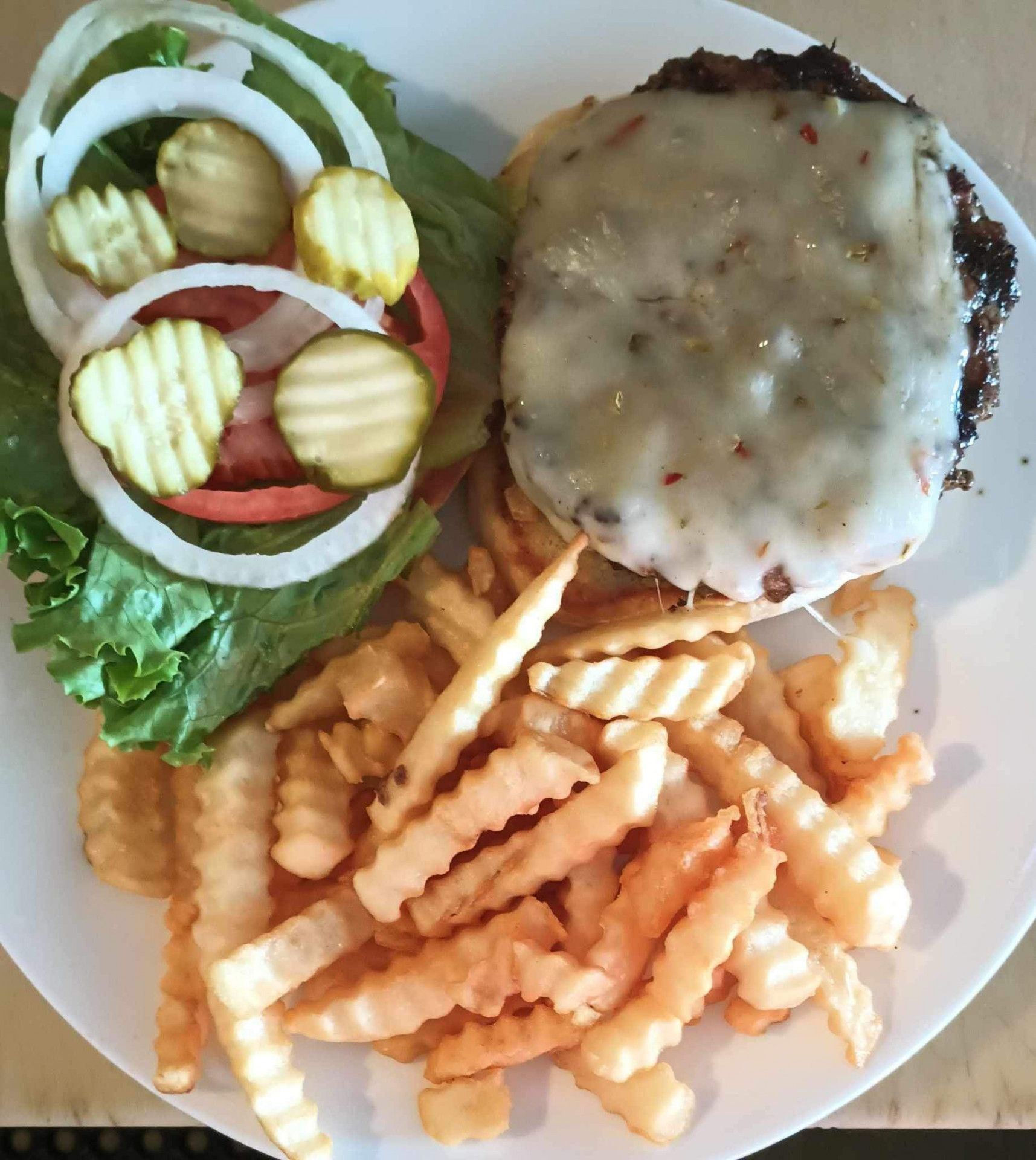A white plate topped with a hamburger and french fries