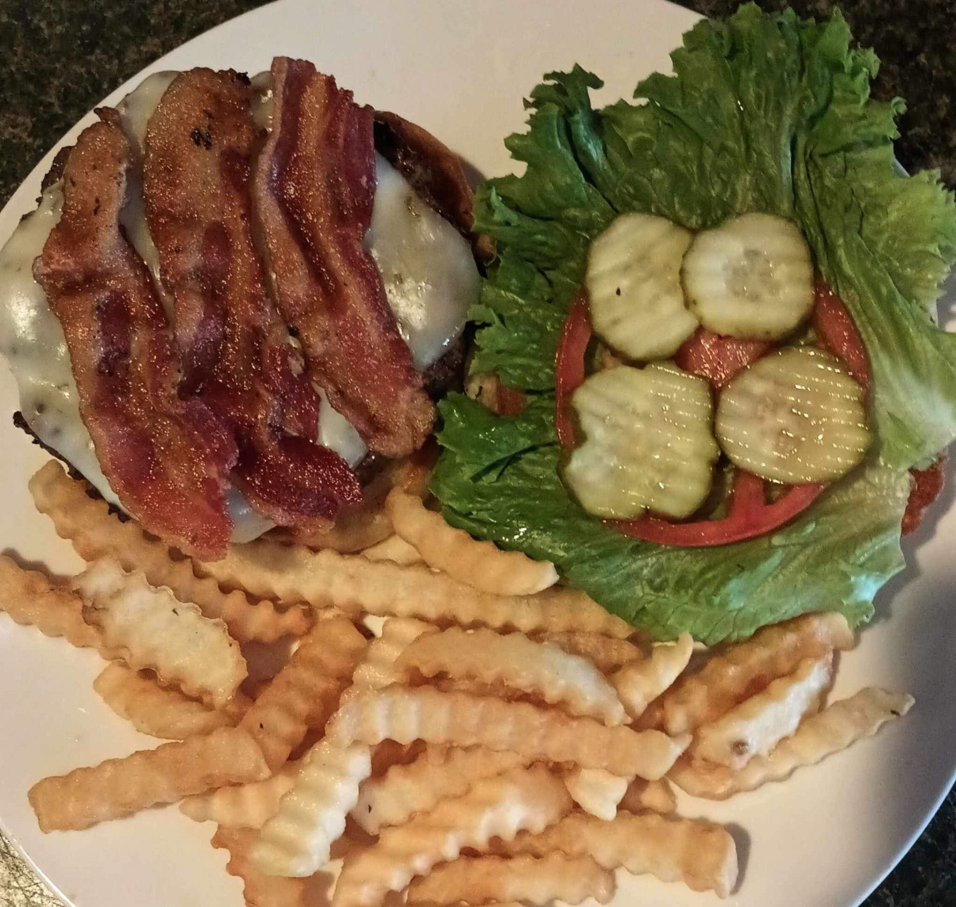 A white plate topped with a hamburger and french fries