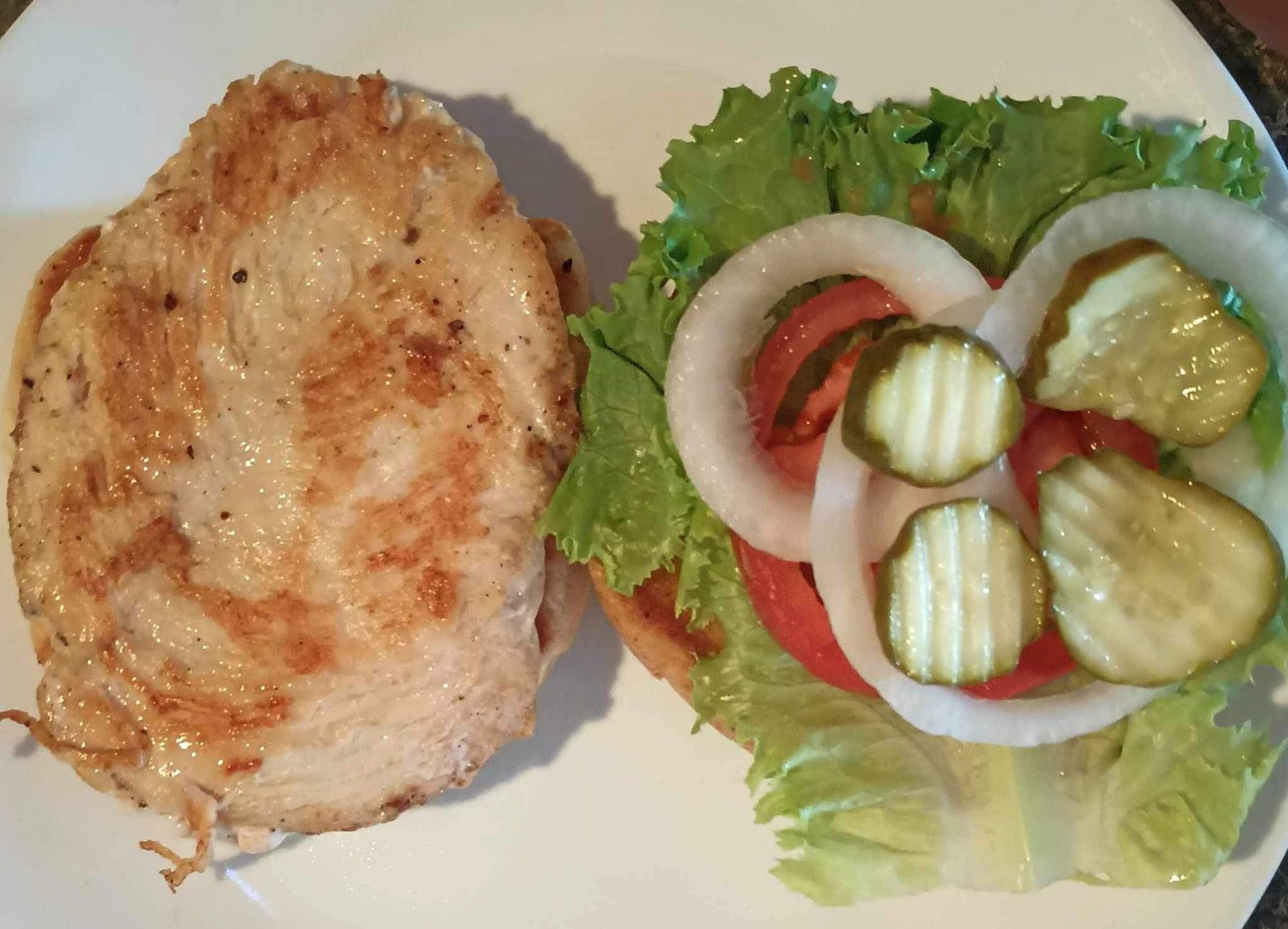 A white plate topped with a sandwich and a salad
