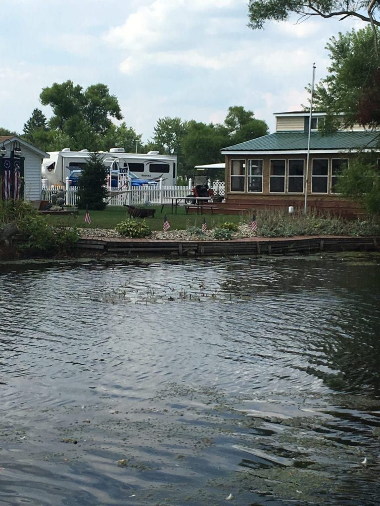 A large body of water with a house in the background
