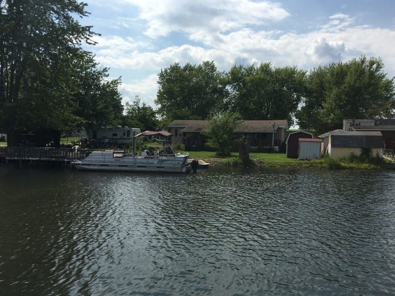 A boat is docked in the water near a house