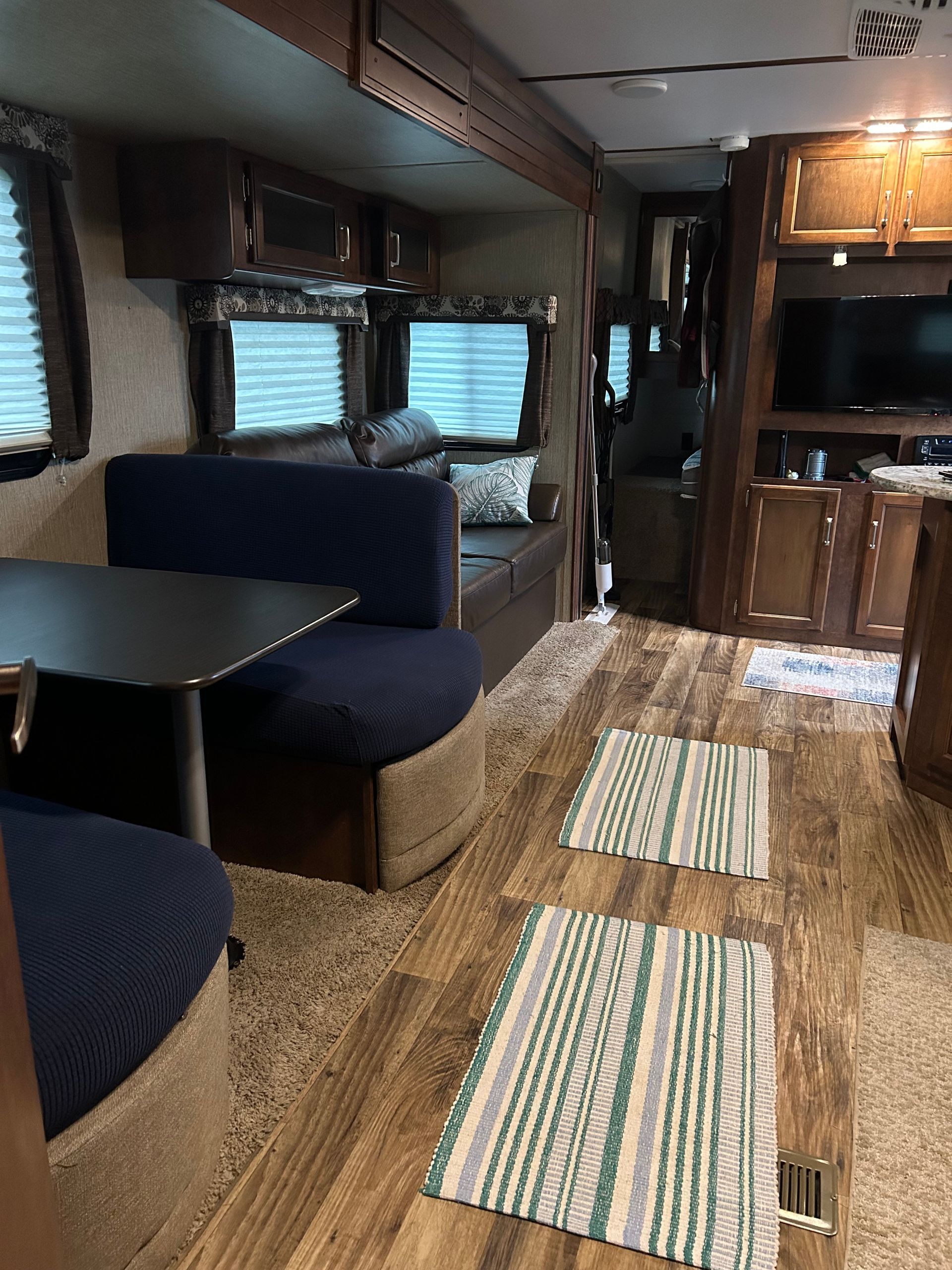 A living room in a rv with a table and a couch
