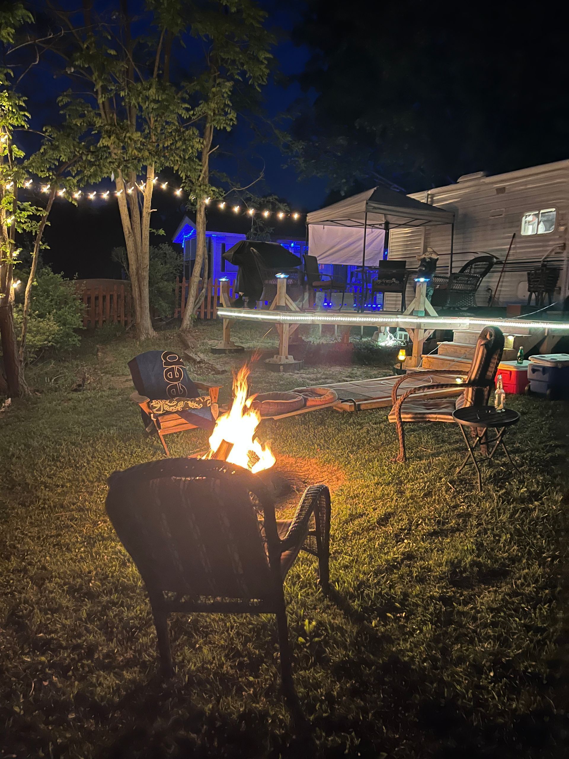 There is a fire pit in the backyard at night
