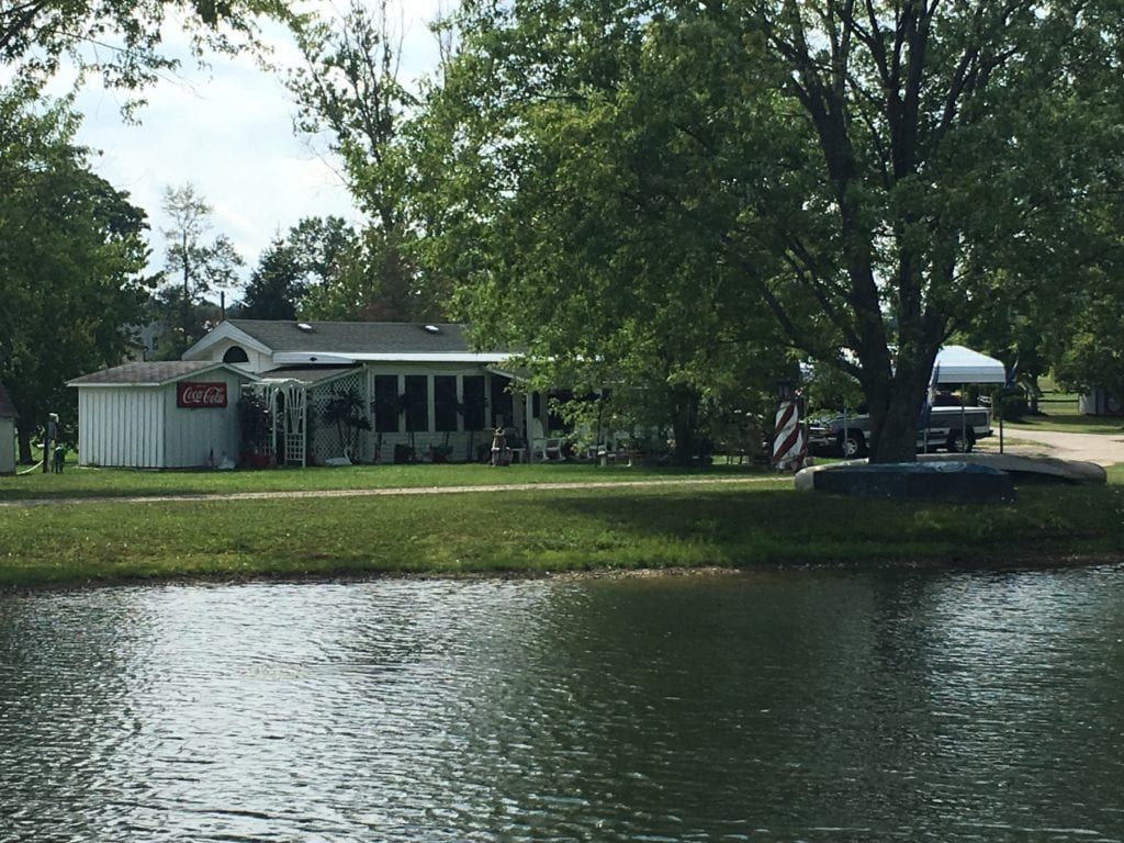 A house is sitting next to a body of water