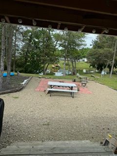 There is a picnic table in the middle of the yard