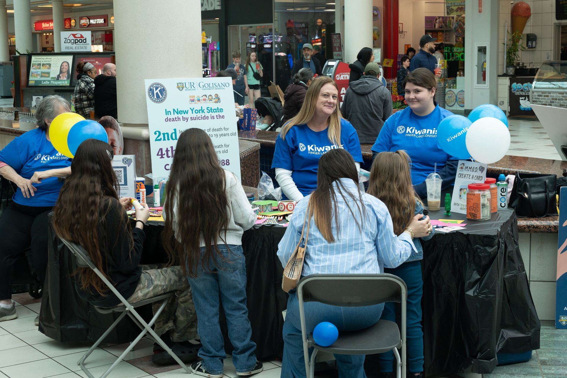 Two presenters at a table, talking with 4 guests