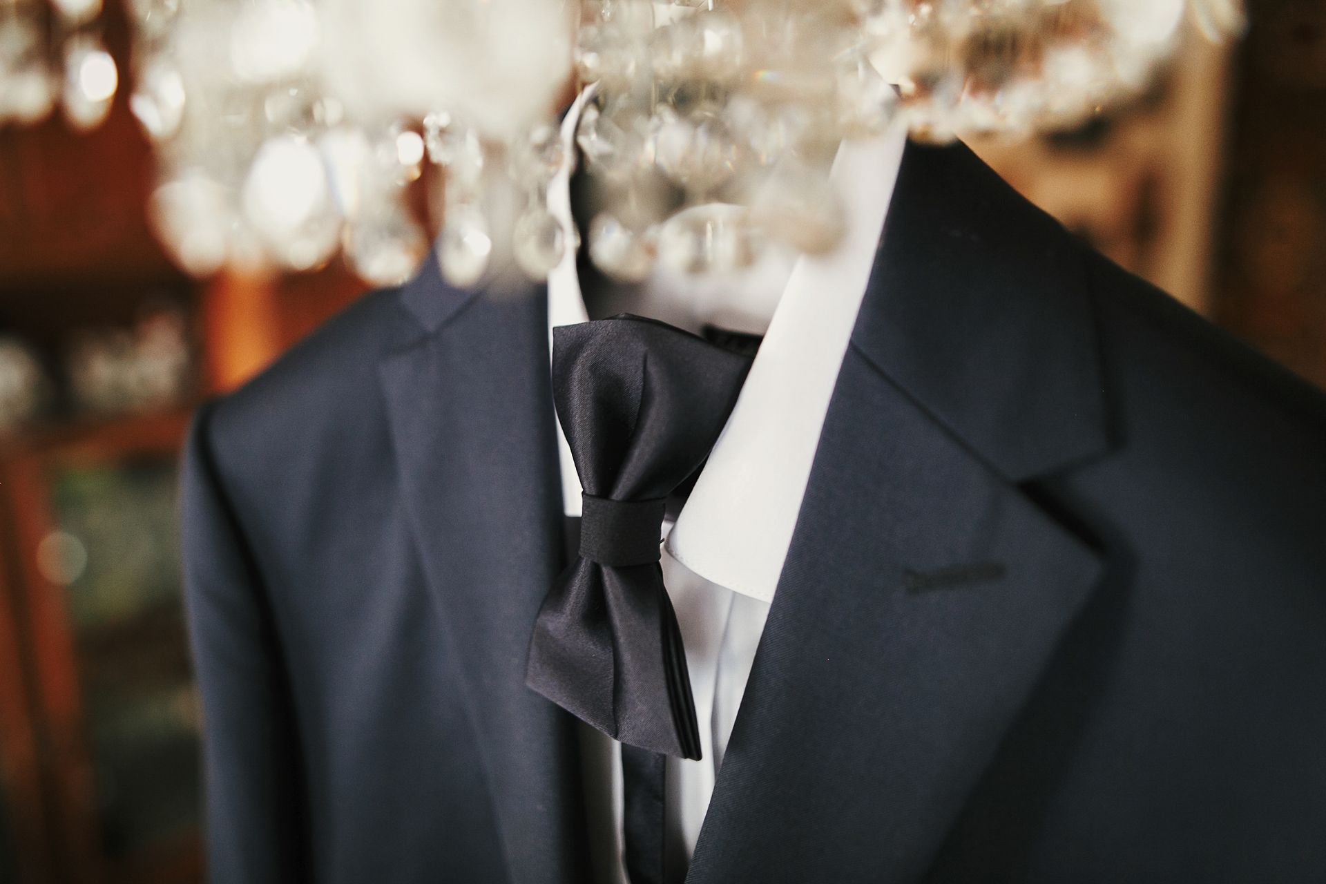 Dark suit jacket on a hanger in a clothing store, with blurred racks in the background