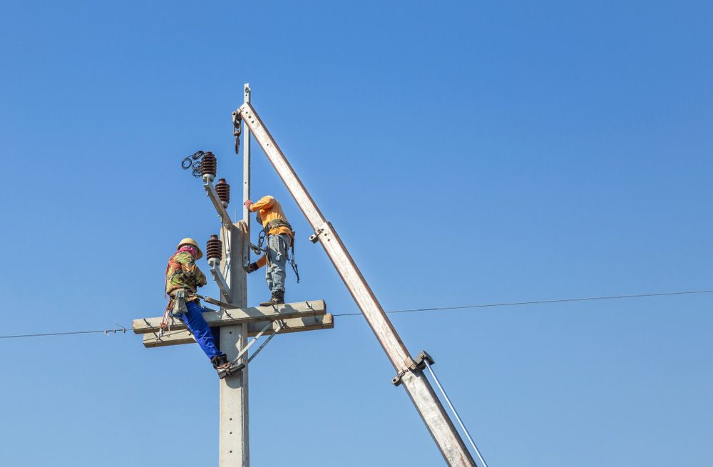 Electrician Climbing Work in the Electric Pole — Electrician in Tamworth, NSW