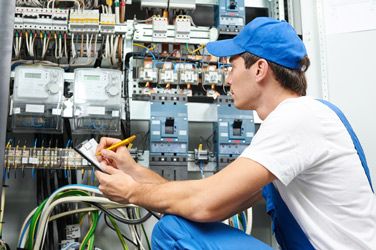 Electrician Inspecting Electric Counter Equipment — Electrician in Tamworth, NSW
