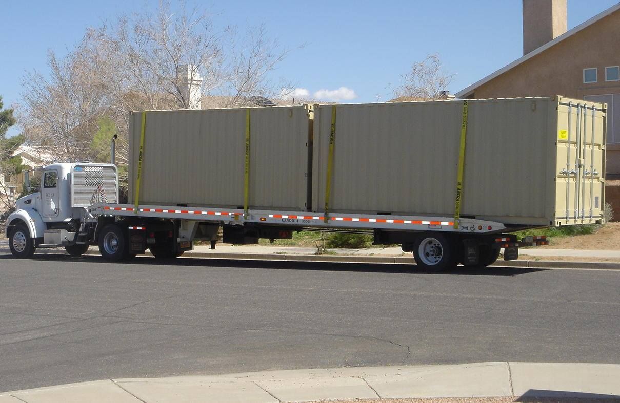 A semi truck is pulling a trailer full of shipping containers