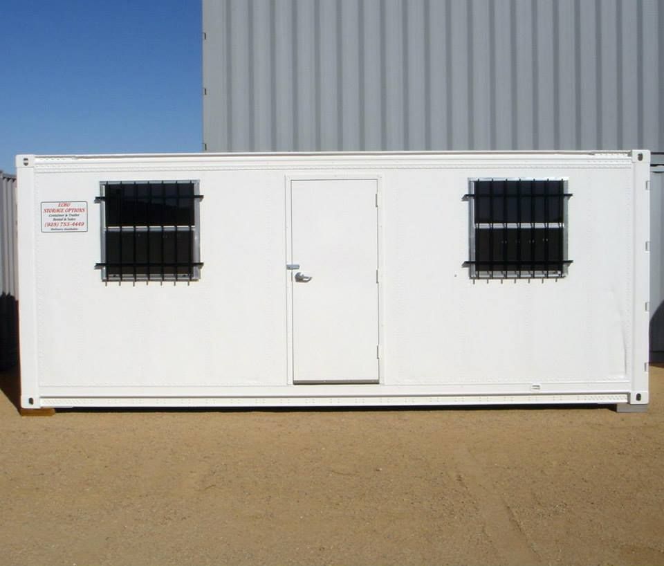 A white building with black bars on the windows