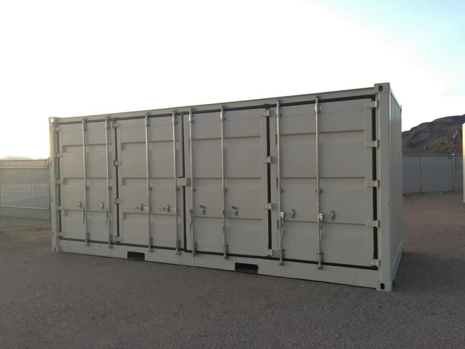 A large white shipping container is sitting in a parking lot