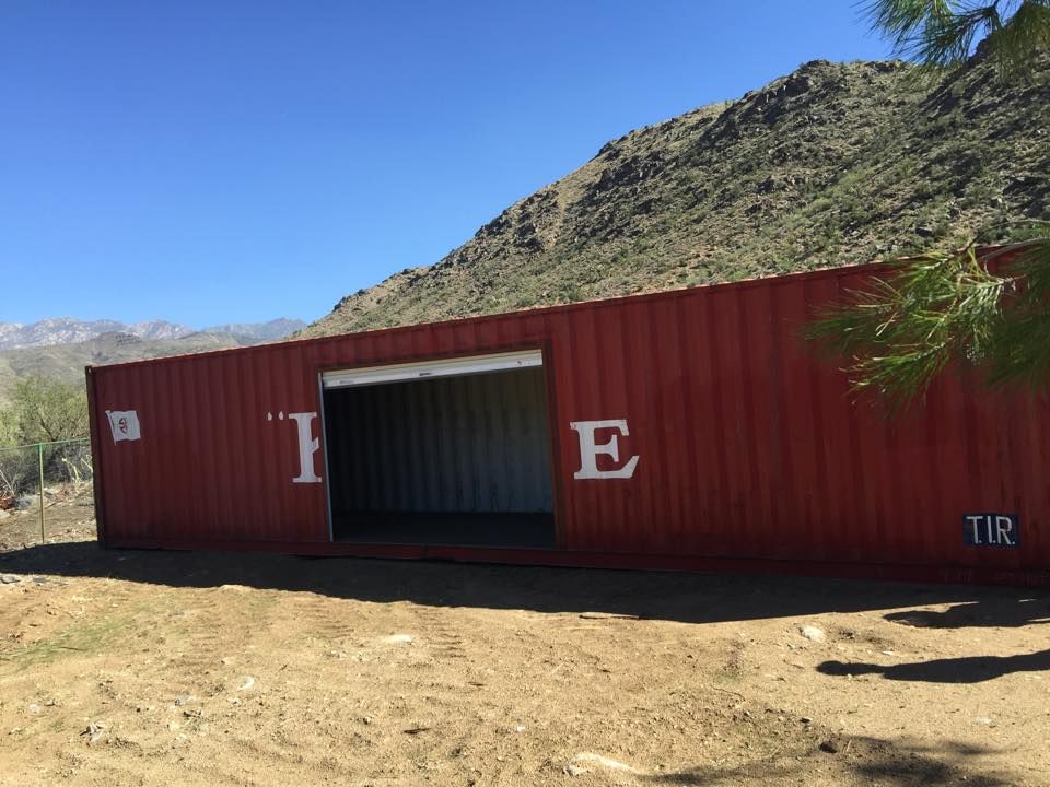 A red shipping container with the letter e painted on it