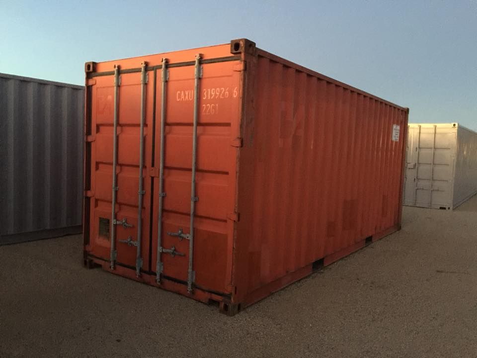 A large red shipping container with the letters tcm on it