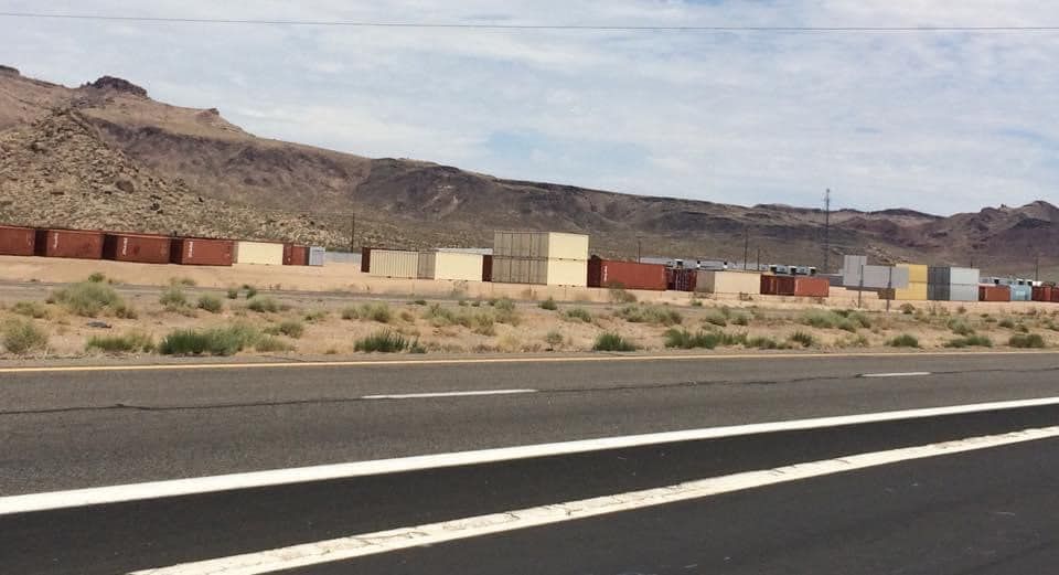 A road with a lot of containers on the side of it