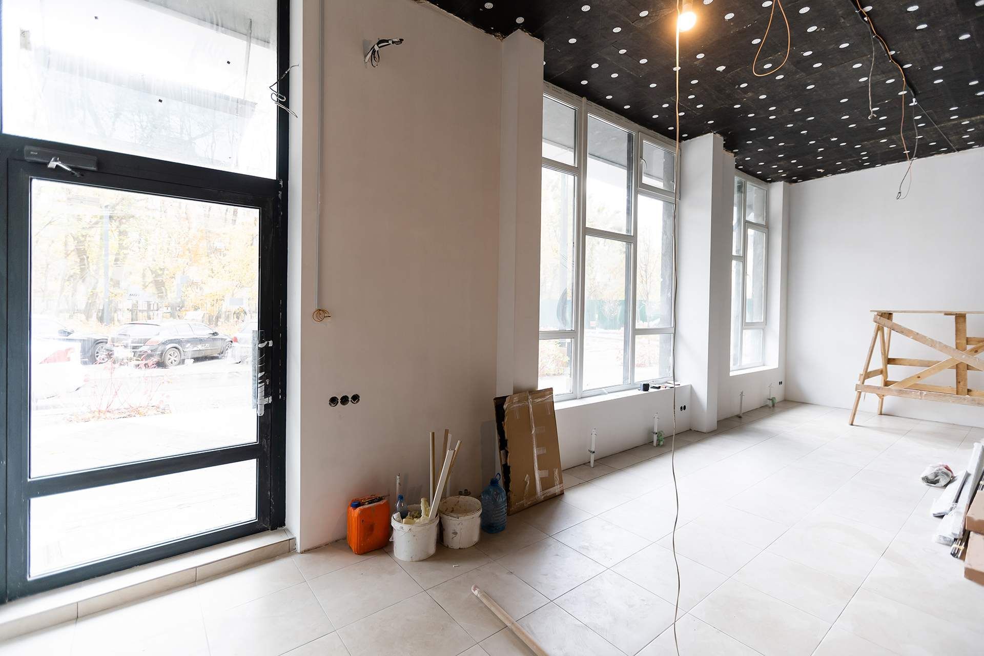 an empty room with a lot of windows and a black ceiling .