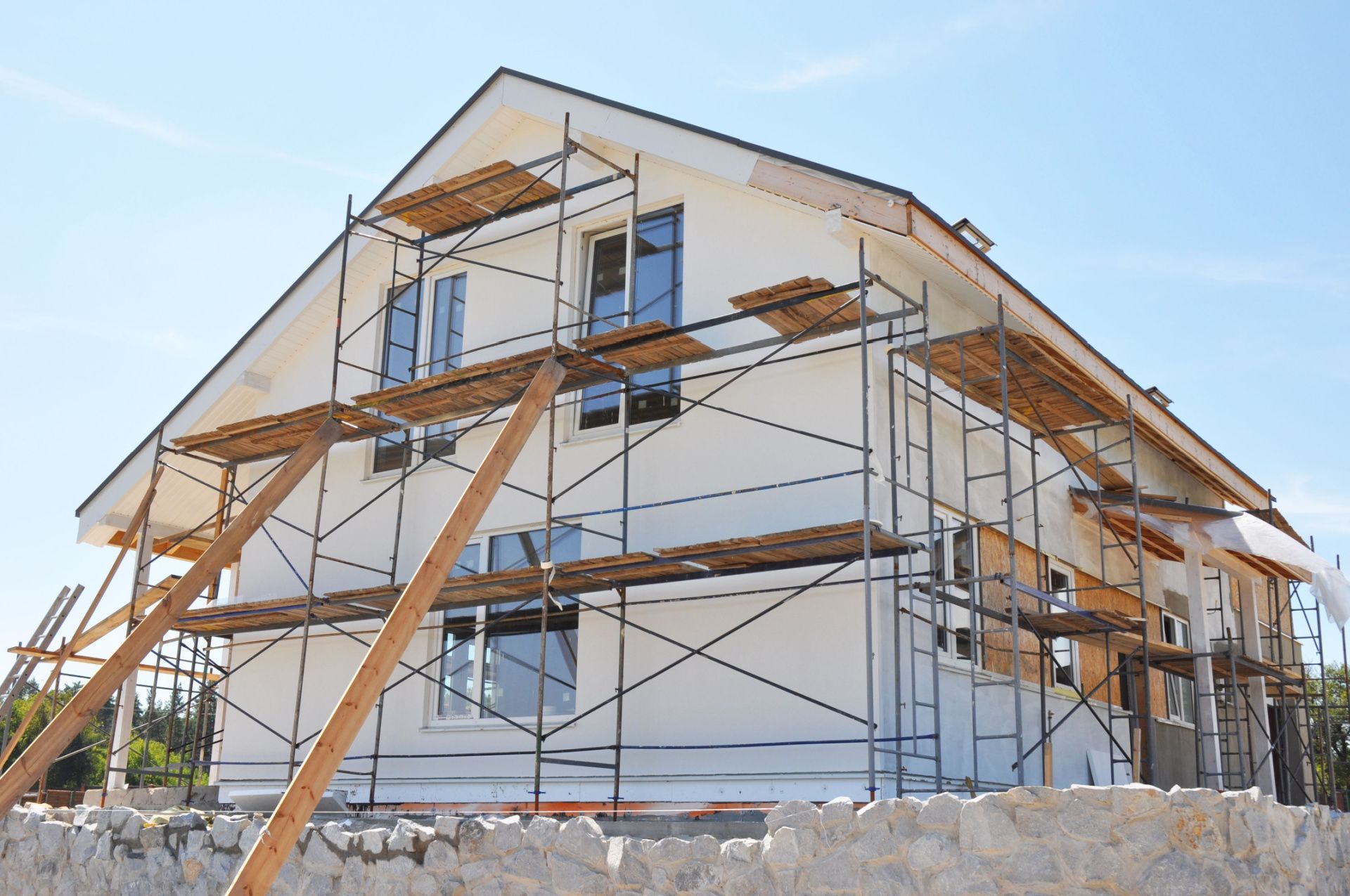 a house is being built with scaffolding around it .