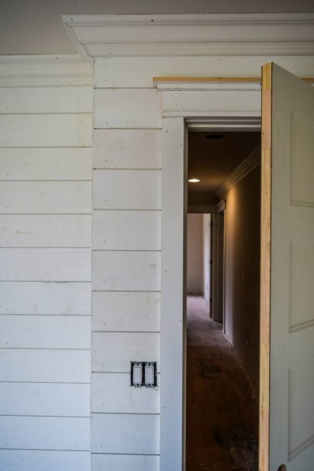 A door is open to a hallway in a house under construction.