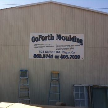 A sign on the side of a building says goforth moulding