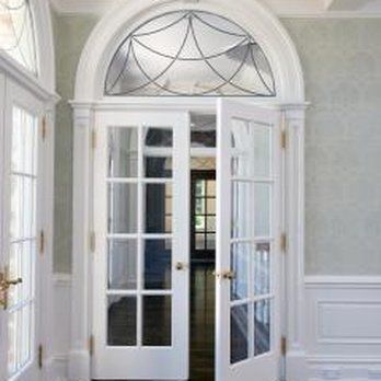 A pair of french doors with stained glass windows in a room.