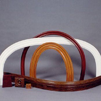 Three different colored wooden arches are sitting on a table