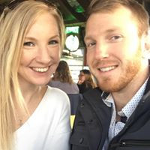 A man and a woman are posing for a picture together and smiling.