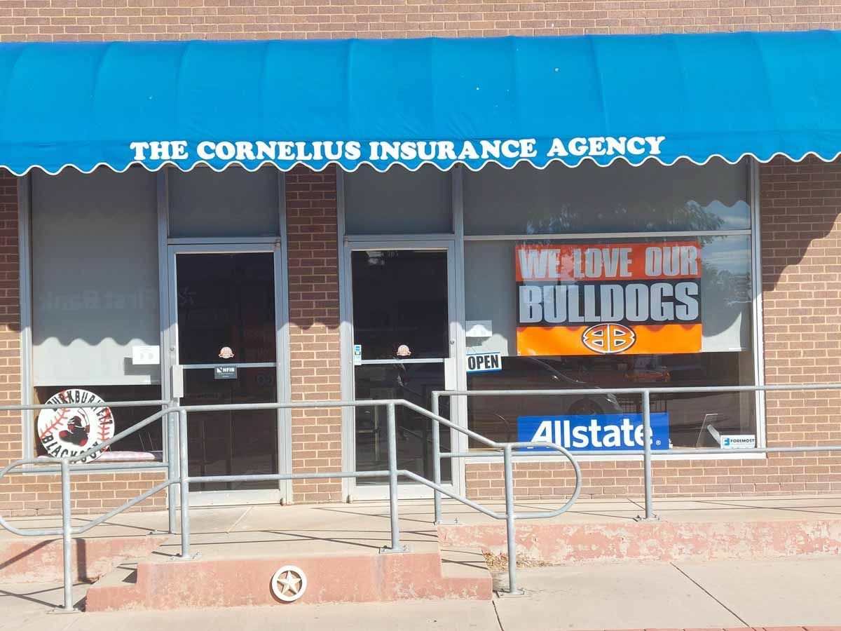 The Cornelius Insurance Agency building with a blue awning and 