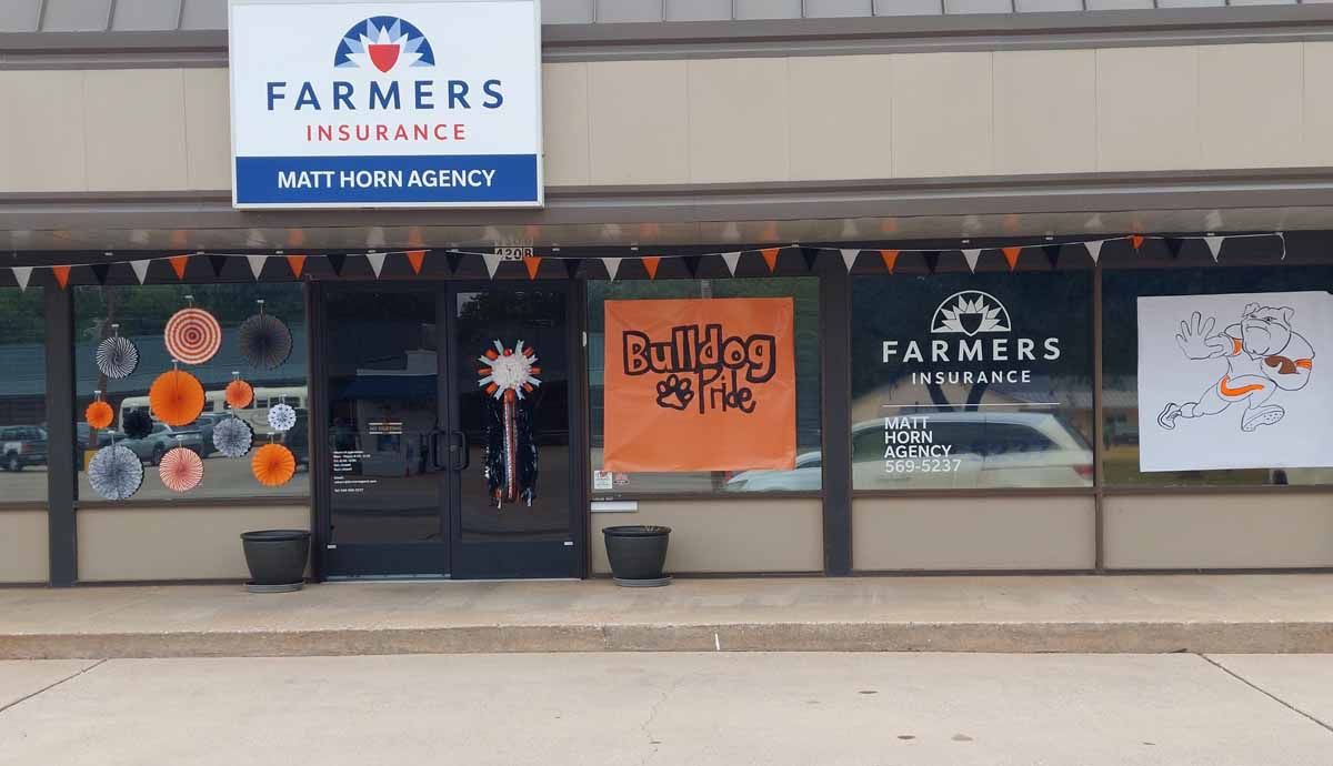 Farmers Insurance office with decorations and pennant banners.