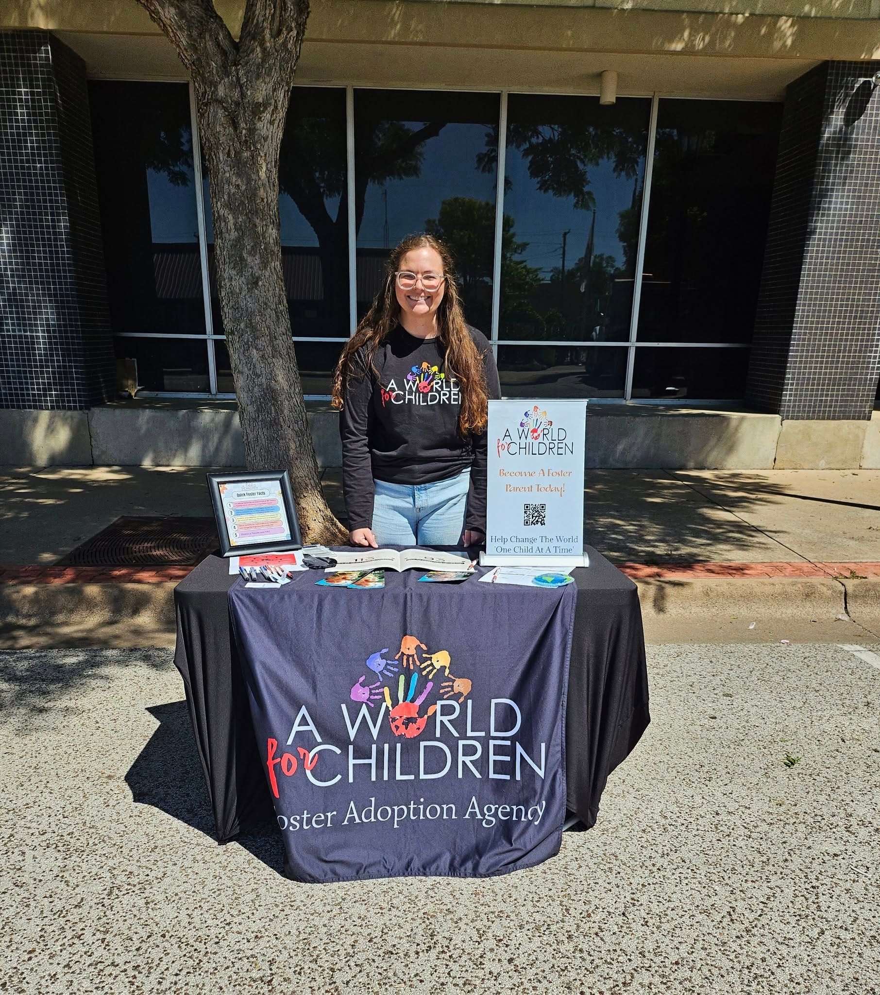 A person stands behind a table with 