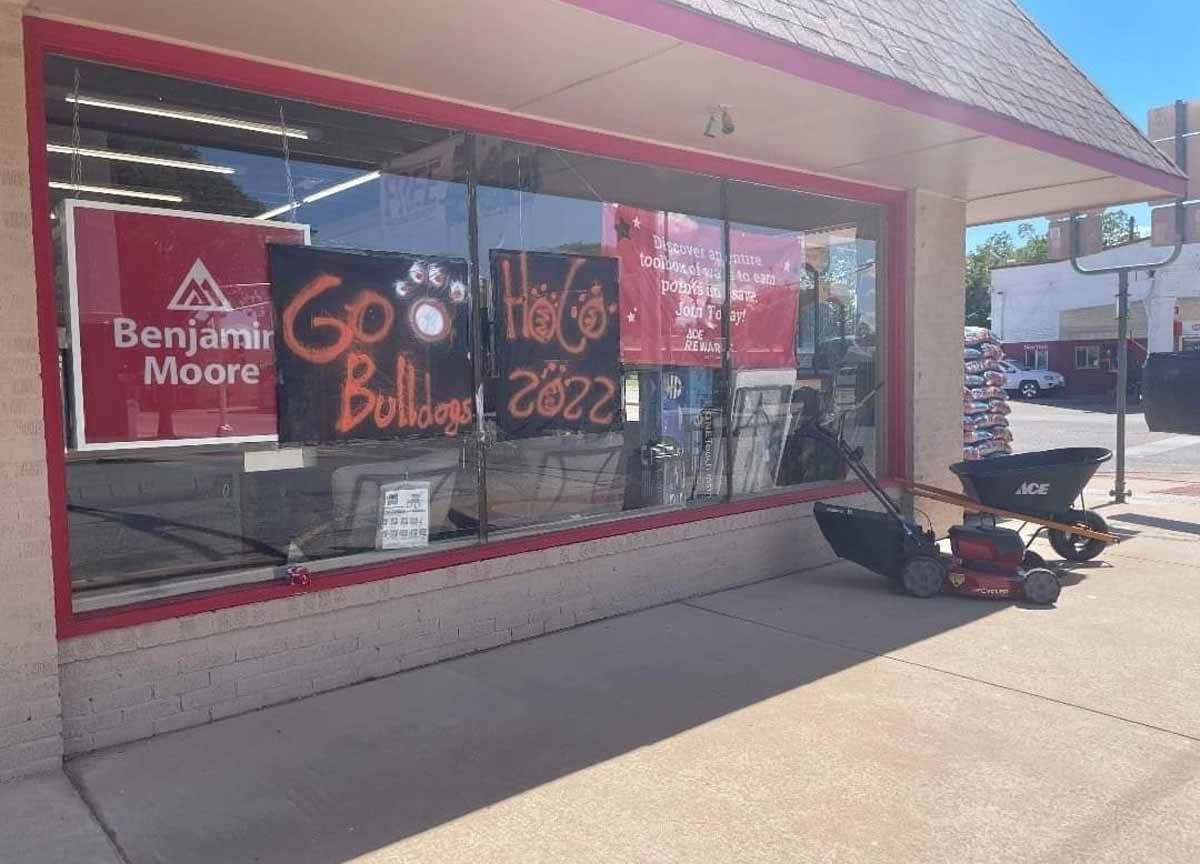 Exterior of a store with a large window. 