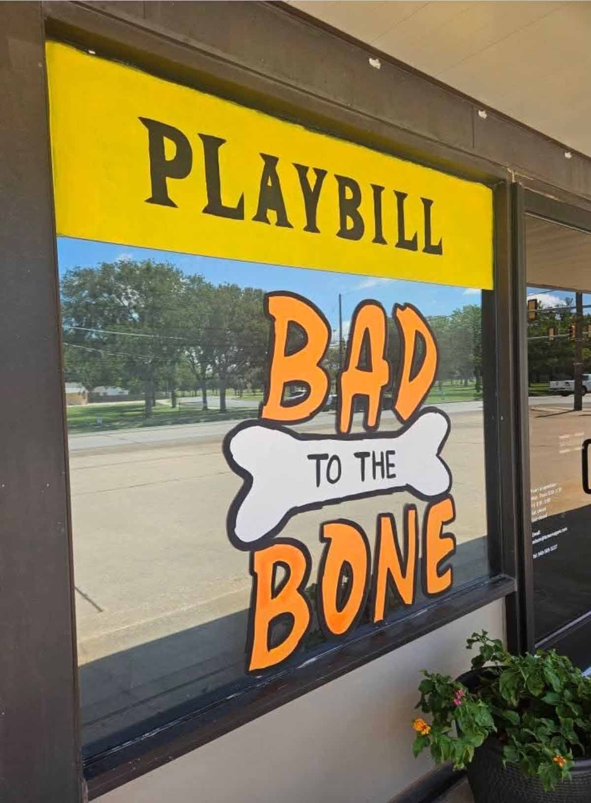 Playbill sign in window: 