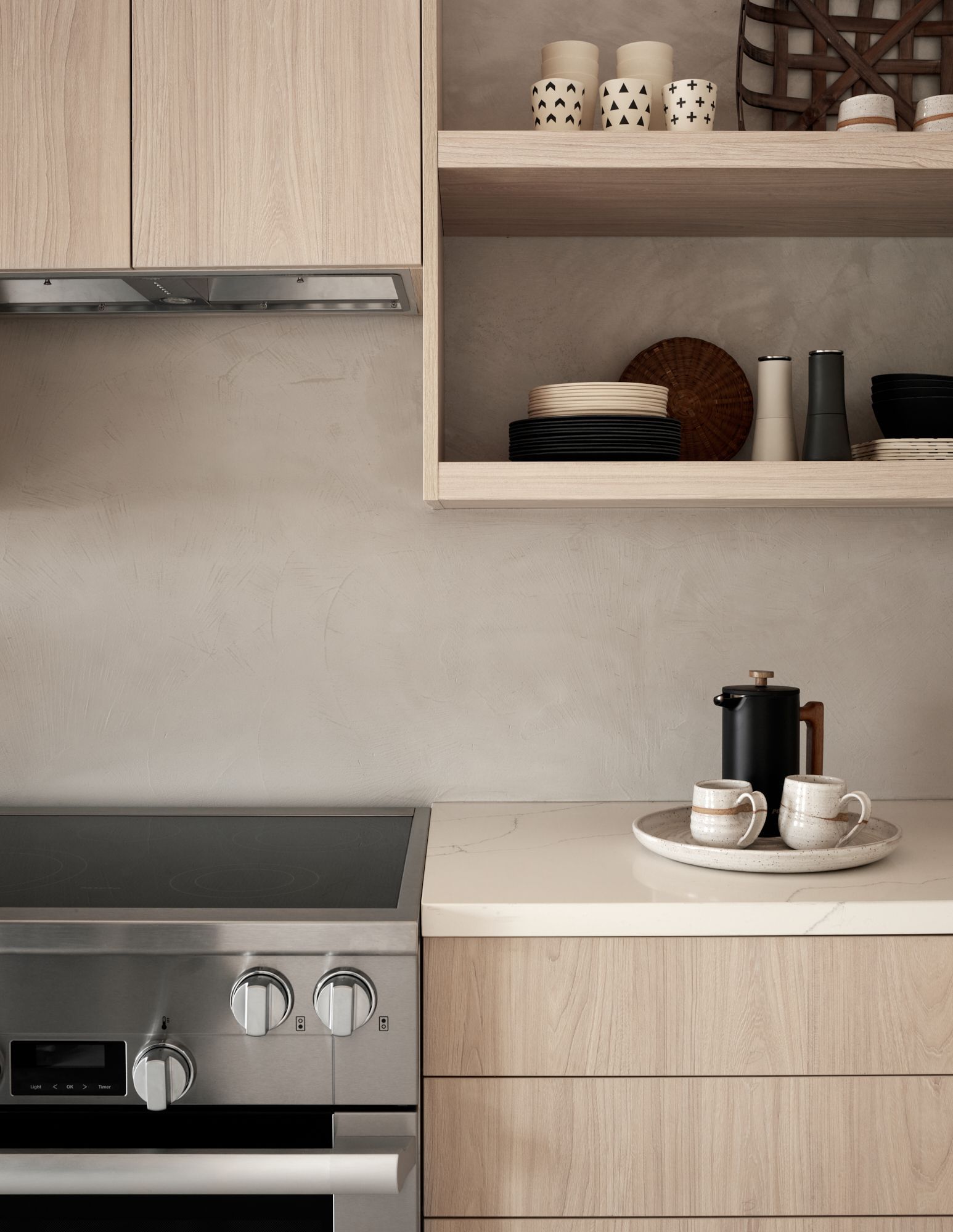 A modern kitchen with light wood cabinets, shelves with dishware and candles, and a stovetop with coffee.