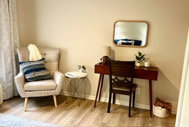 There is a chair and a desk in the room.