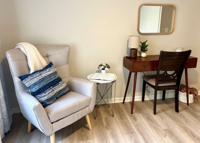 There is a chair and a desk in the room.