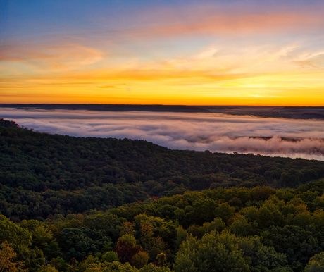 A sunset over Wisconsin valley with trees and clouds