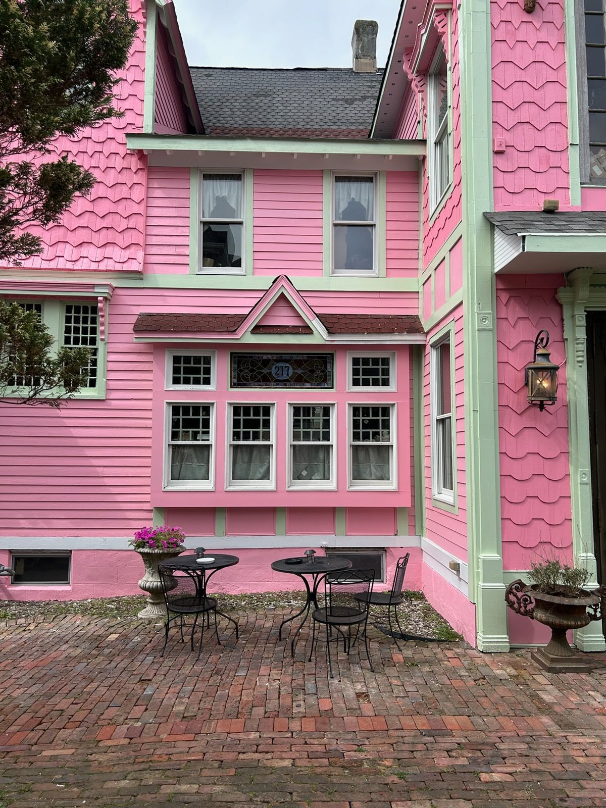 A teapot and cup of tea are on a tray on top of an open book.