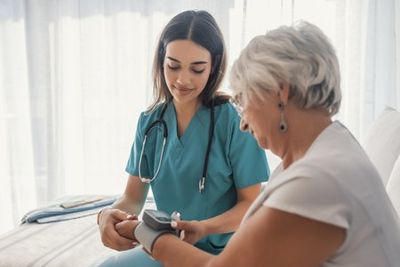 In-home Elderly Care — Woman Checking the Blood Pressure in Lincoln, NE