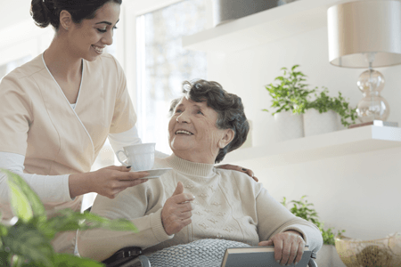 Elderly Care — Woman Nursing an Elderly Woman in Lincoln, NE