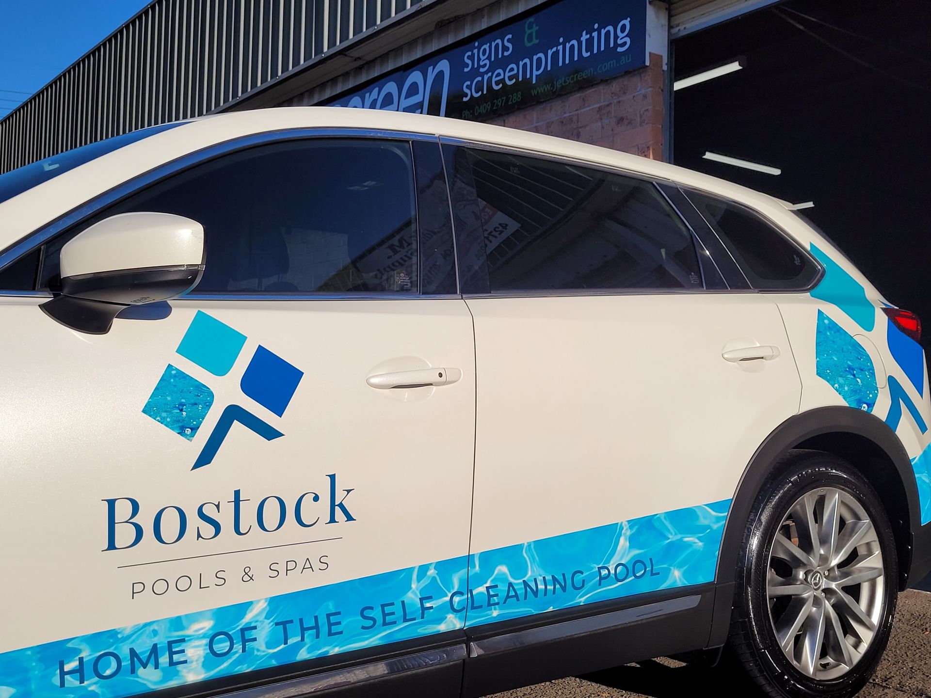 Car Showing a Vehicle Wrap with a Company Logo Example — Professional Signs in Wollongong