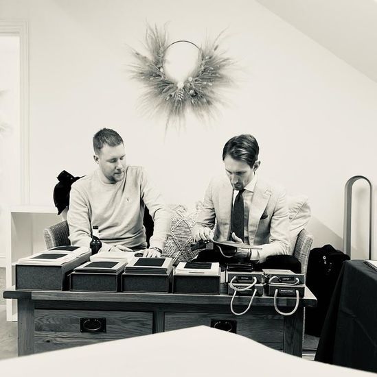 A black and white photo of two men sitting at a table