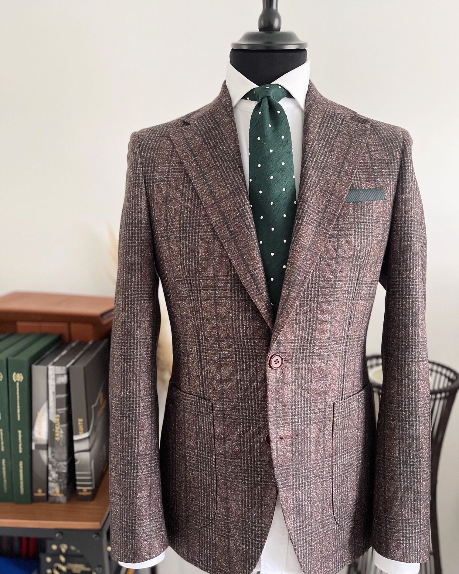 A man is wearing a suit and tie on a mannequin.