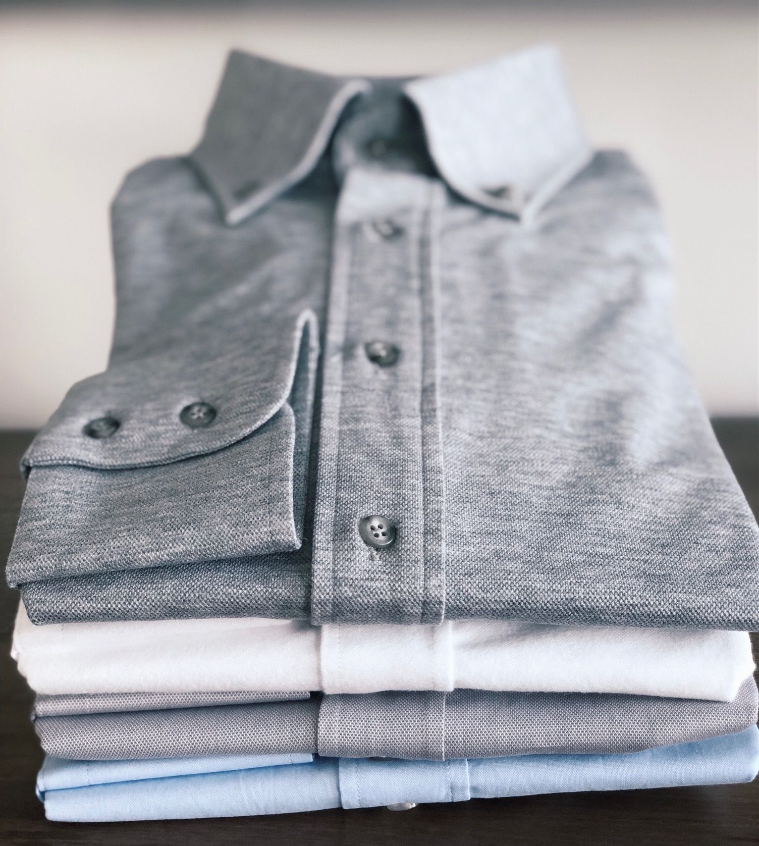 A stack of folded shirts on a table