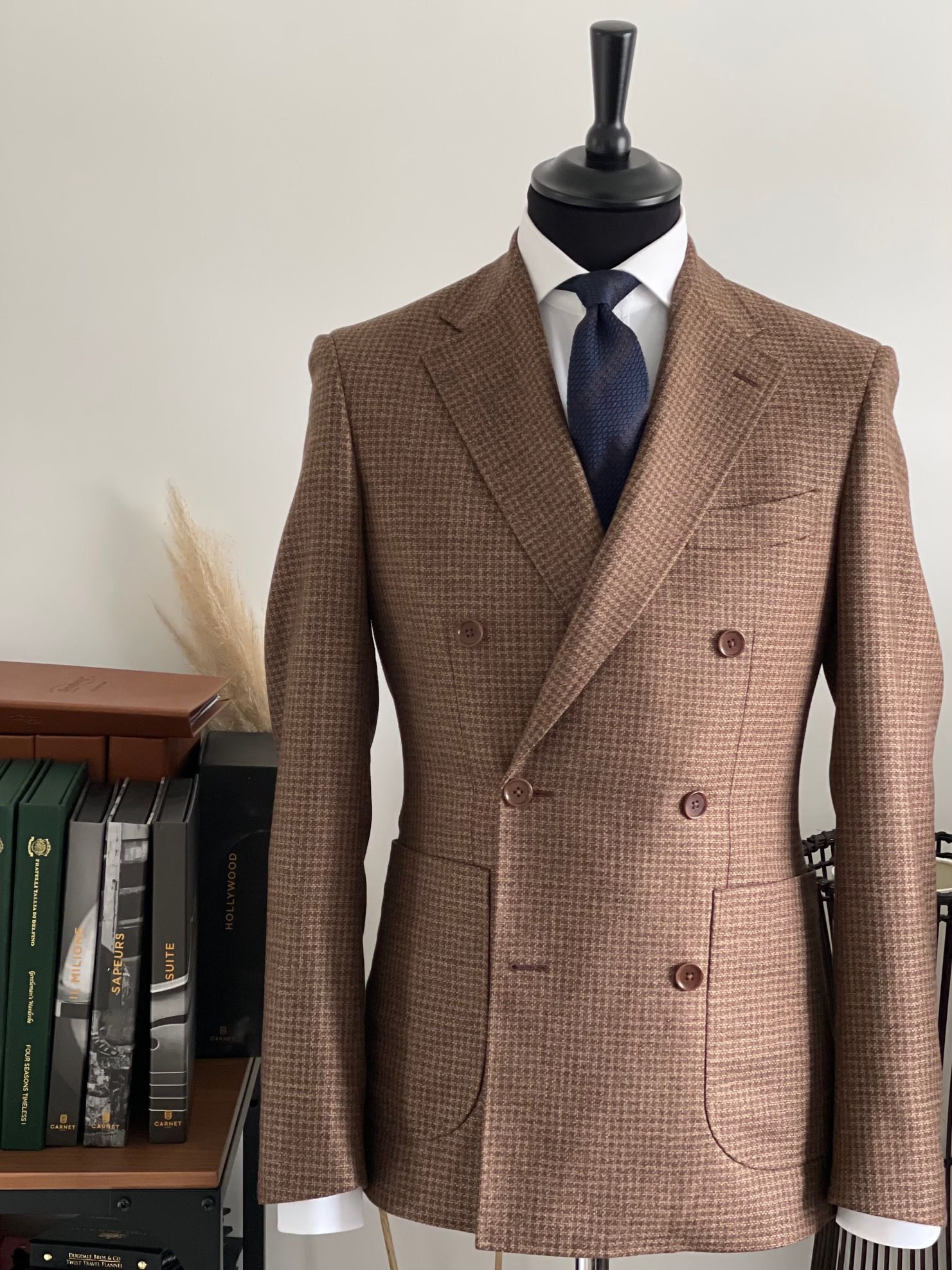 A brown suit and tie are on a mannequin.