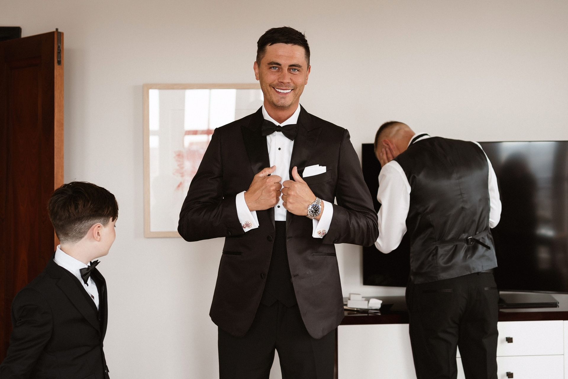 A man in a tuxedo is getting ready for his wedding.
