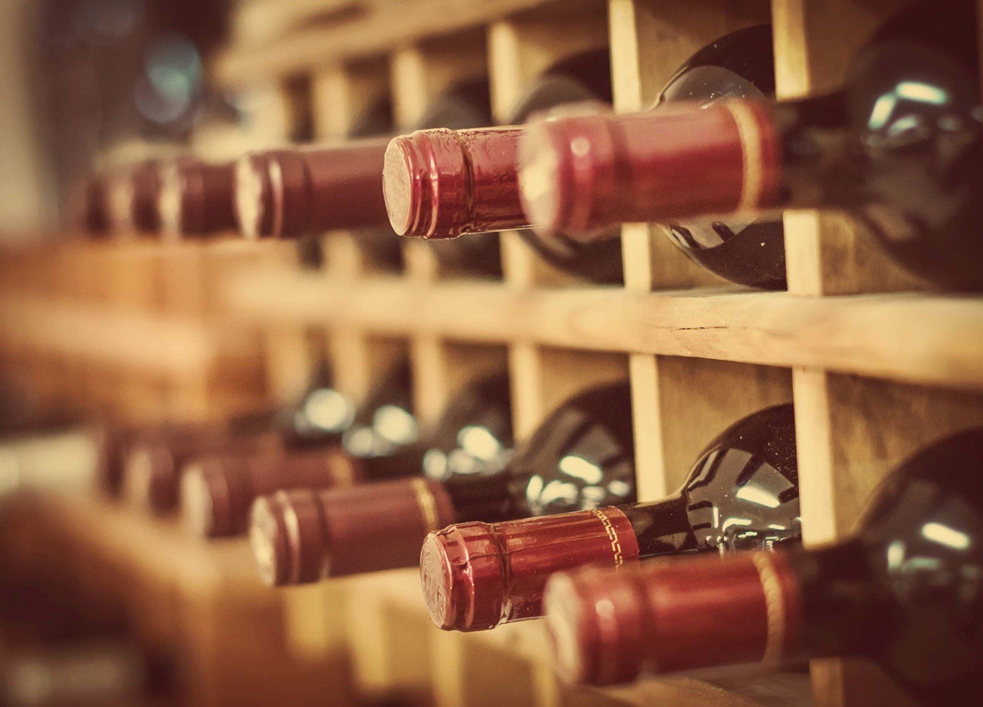 Red Wine Bottles Stacked on Wooden Racks — Austin, TX — Wansley Refrigeration