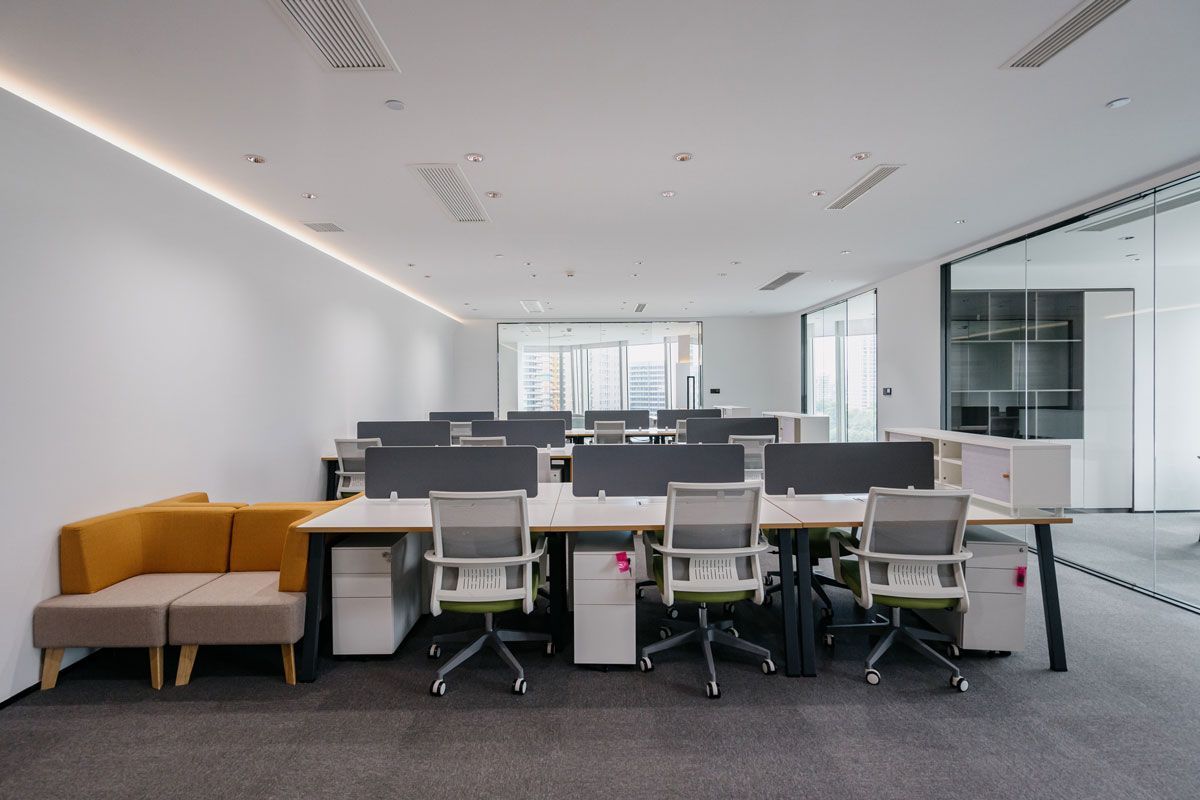 A large office with a lot of desks and chairs