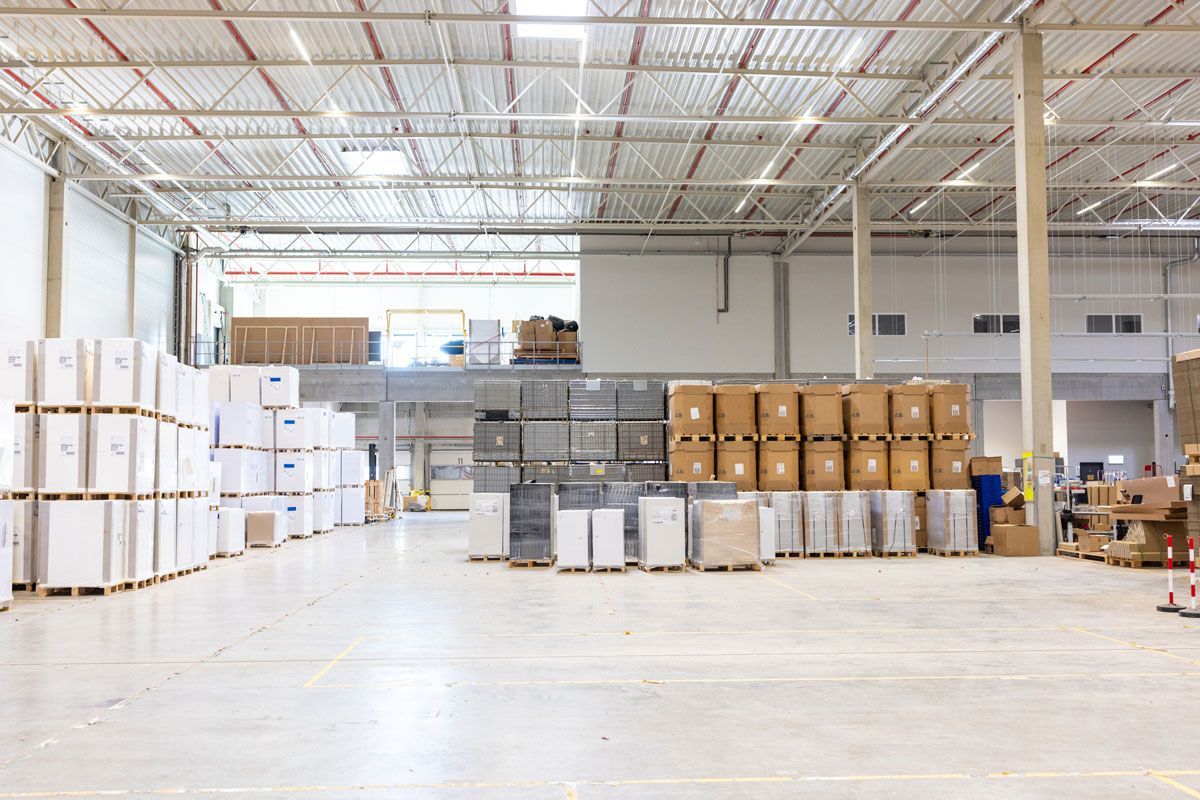 A large warehouse filled with lots of boxes and pallets.
