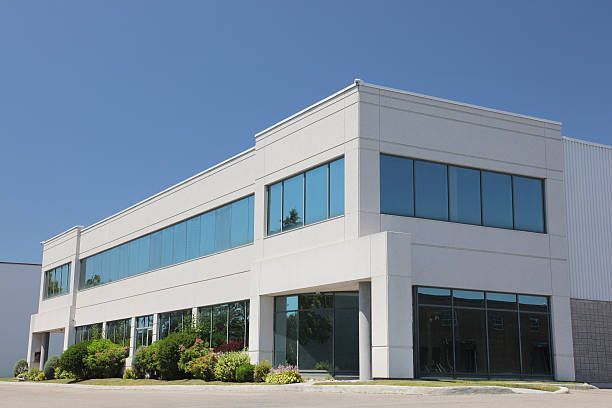 A large white building with a lot of windows on a sunny day.