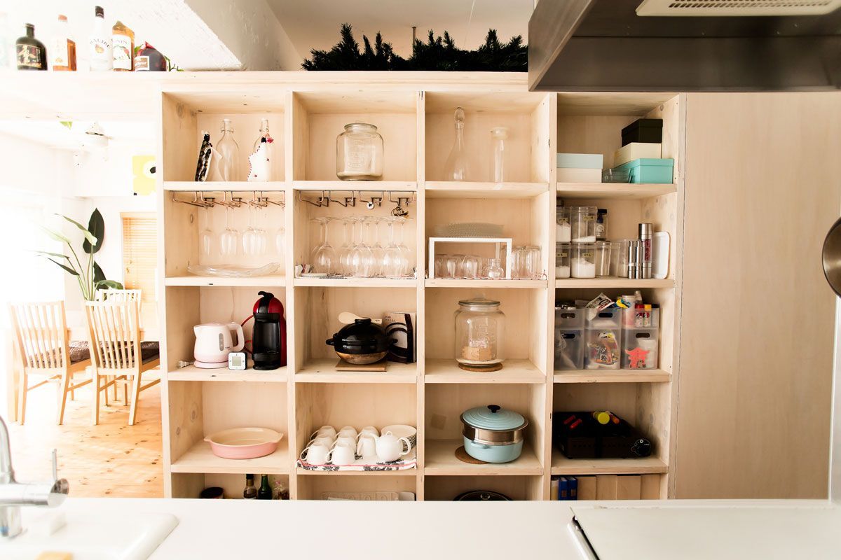 A kitchen with a lot of shelves and a sink.
