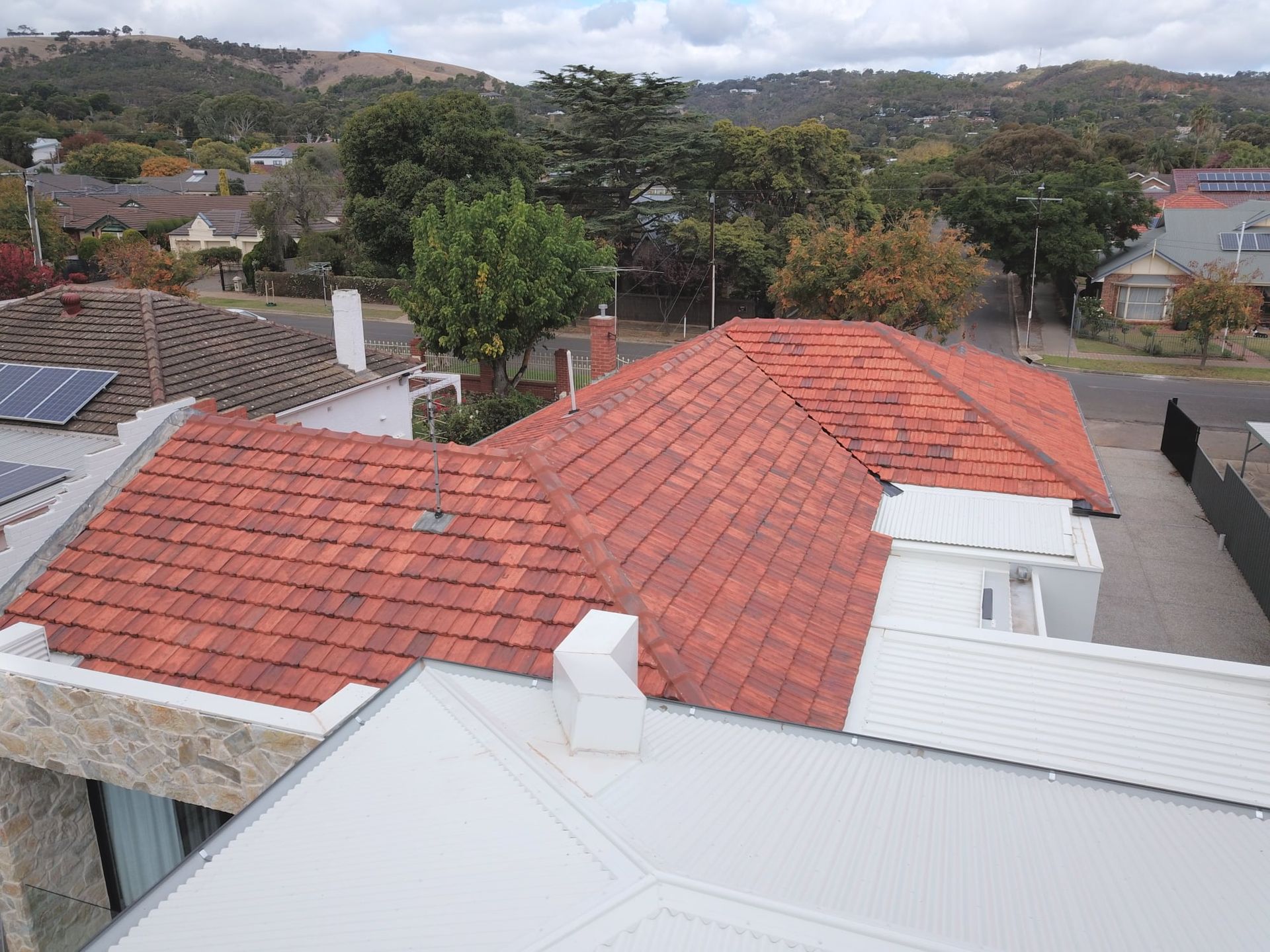 An aerial view of a house with a red tiled roof